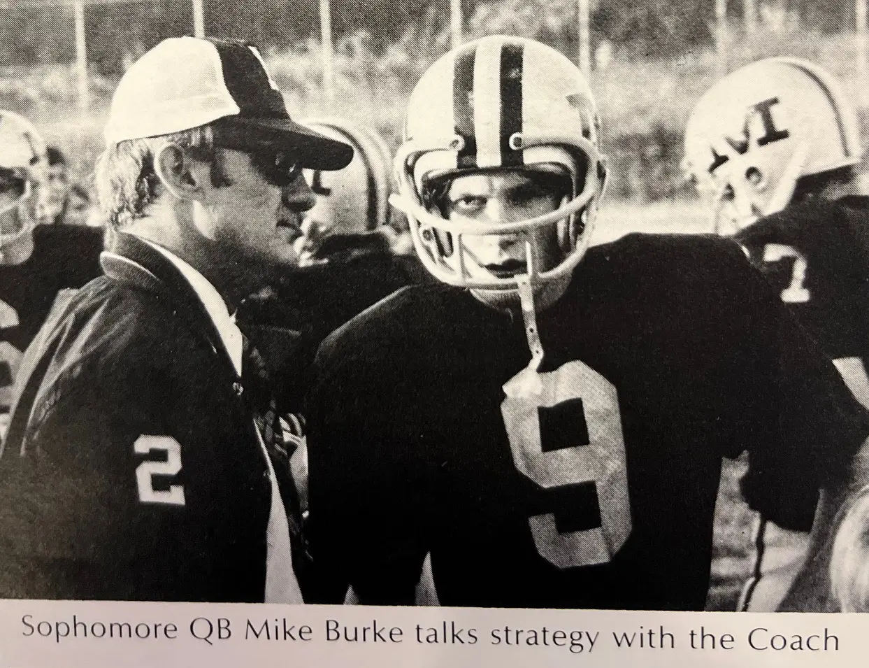 Sophomore QB Mike Burke talks strategy with coach